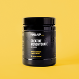 tub of creatine monohydrate on yellow background