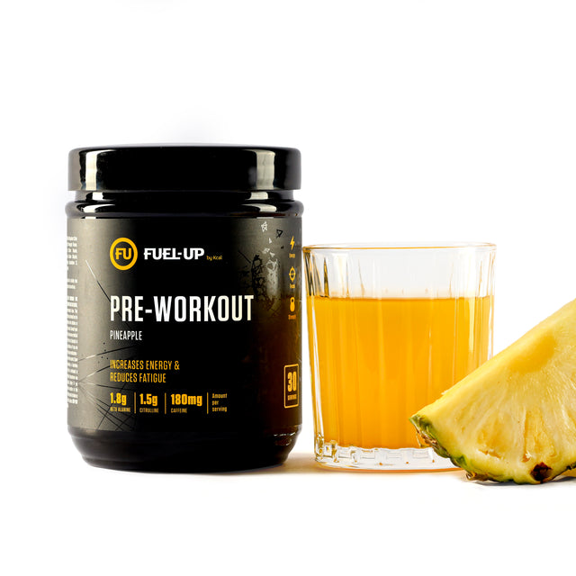 Container of pre-workout supplement with fresh pineapple